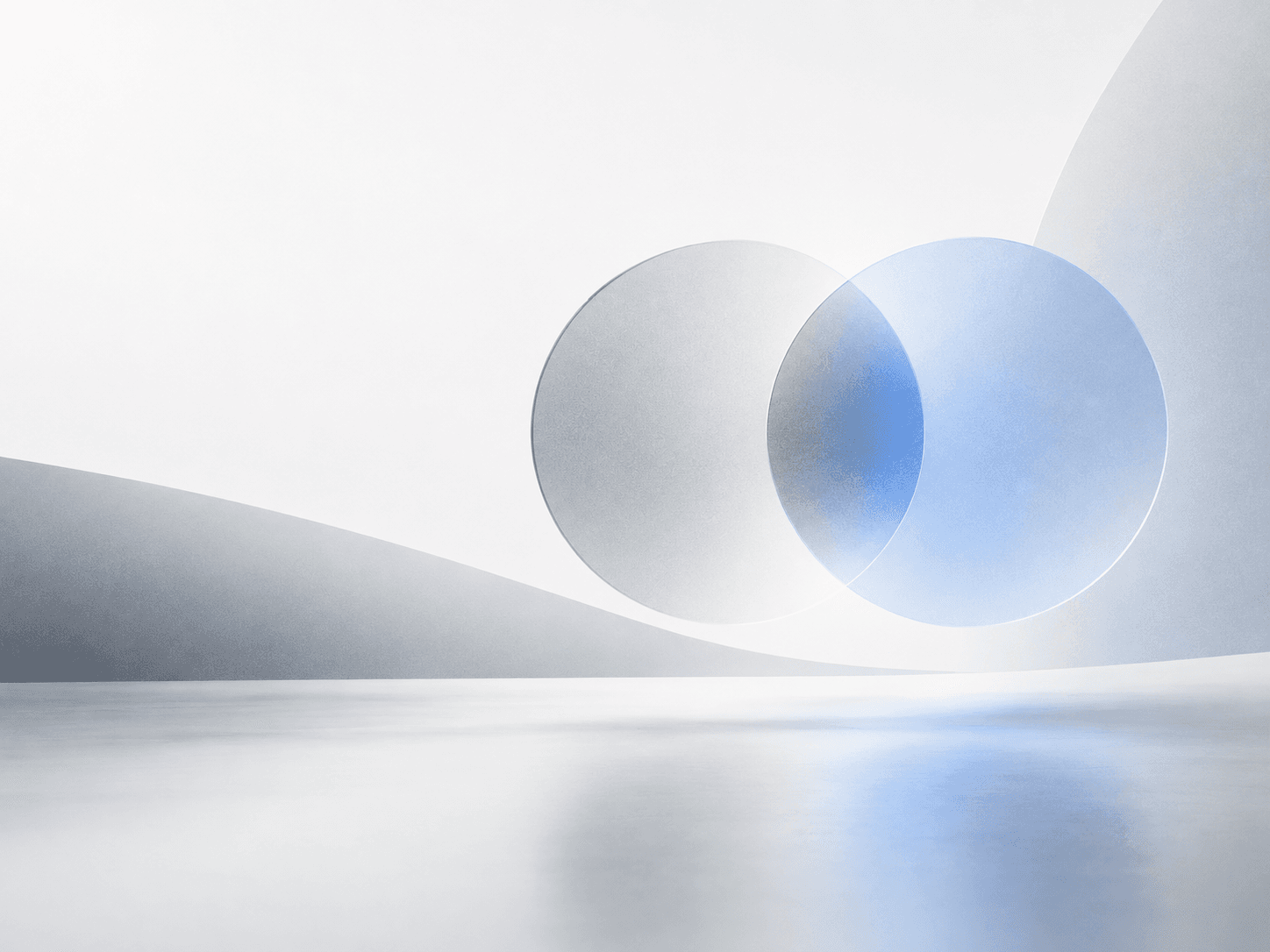 Abstract render of two translucent spheres, one silver and one blue, reflected on a glossy surface